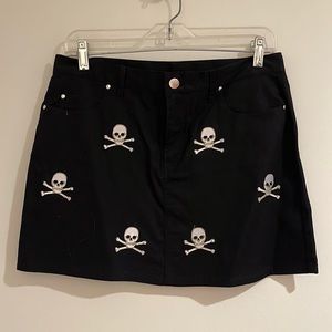 Black Mini Skirt, embroidered skulls, back and front pockets. Size 4.  Front zip